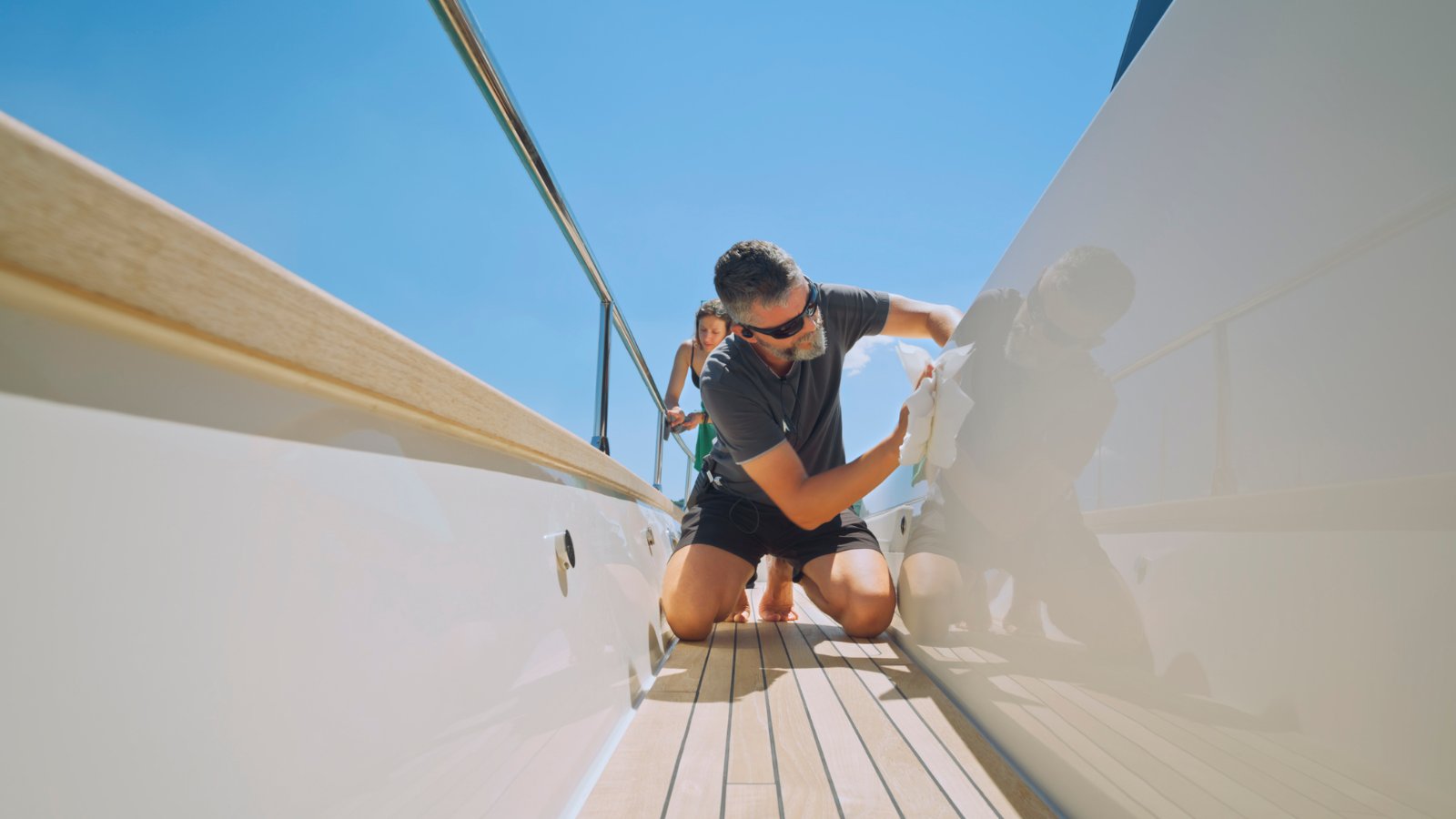 Senior deckhand carrying out deck maintenance on a superyacht